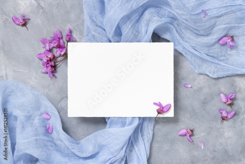 Obraz na płótnie Blank card on fabric near wild purple flowers top view on gray, spring wedding mockup w salonie