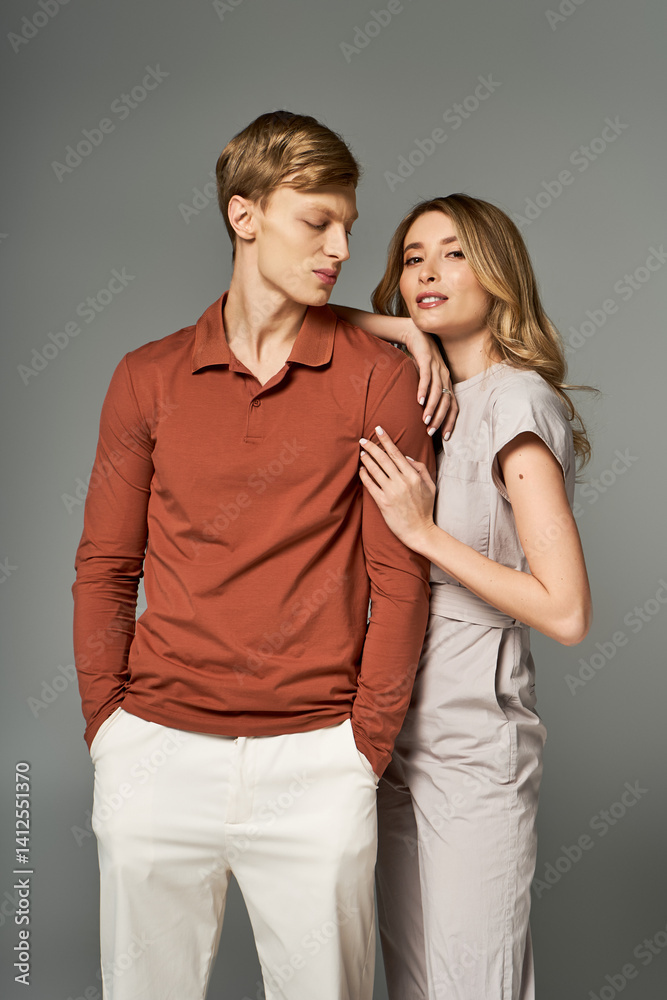 Stylish young couple showcasing spring fashion trends in a modern studio setting Stylish young couple showcasing spring fashion trends in a modern studio setting