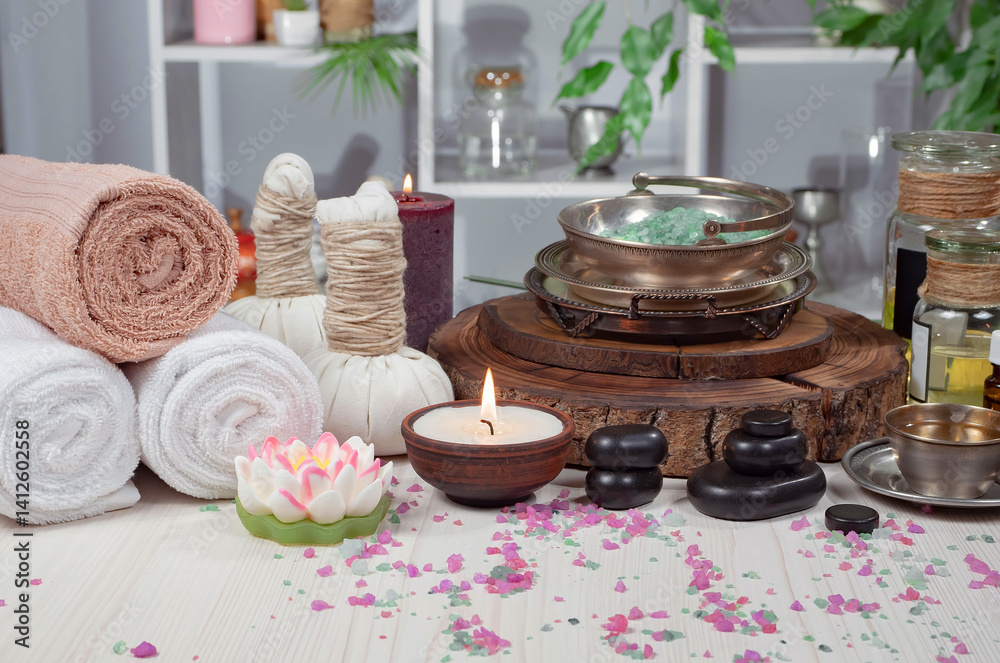 Spa treatment with candles and towel on wooden table, close up