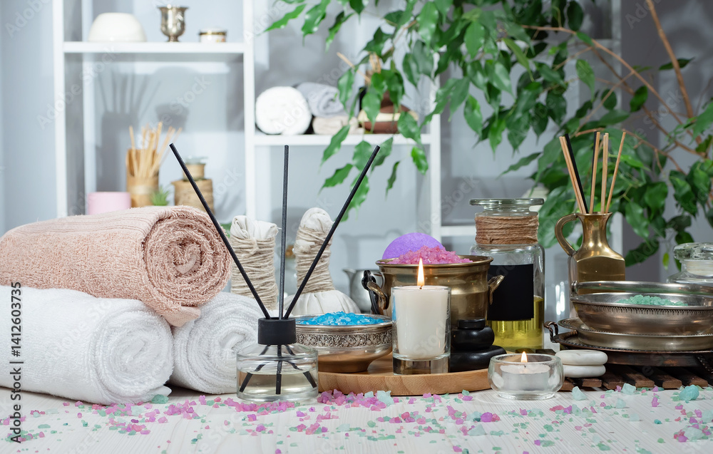 Spa treatment with candles and towel on wooden table, close up