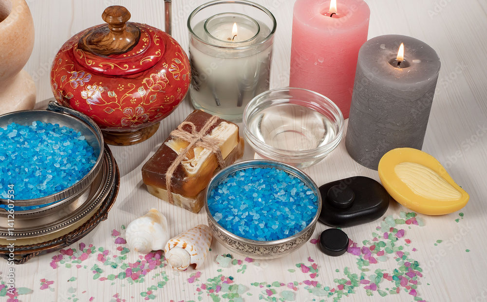 Spa treatment with candles and towel on wooden table, closeup