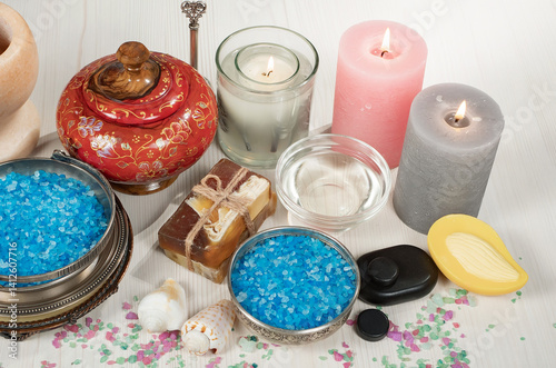 Spa treatment with candles and towel on wooden table, closeup