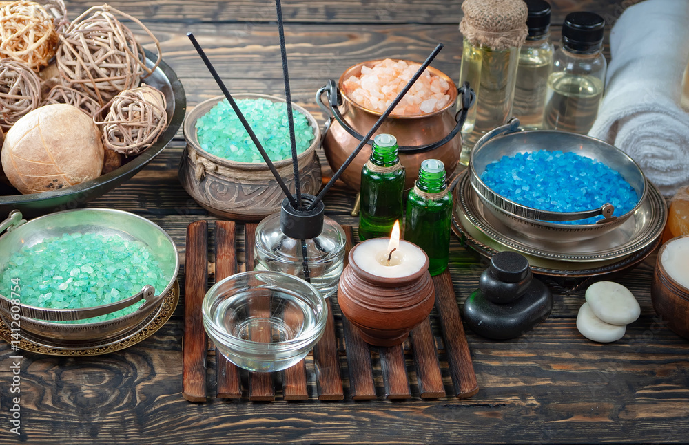 Spa treatment with candles and towel on wooden table, closeup