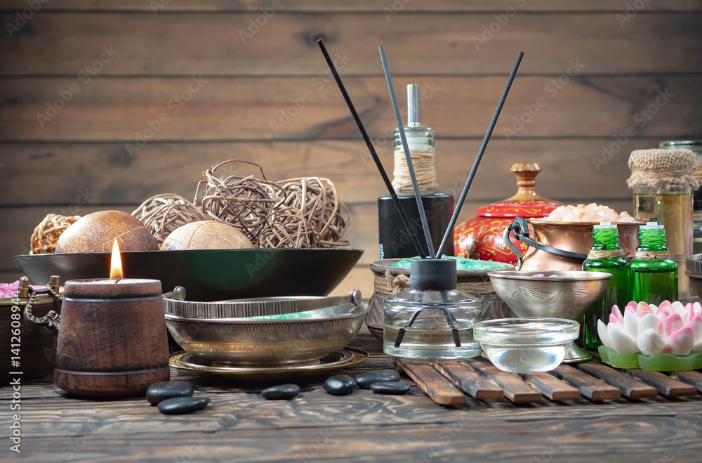 Spa treatment with candles and towel on wooden table, closeup