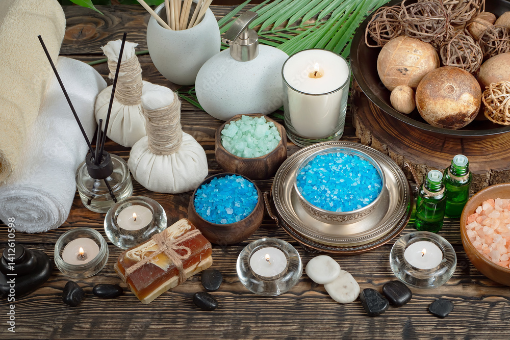 Spa treatment with candles and towel on wooden table, closeup