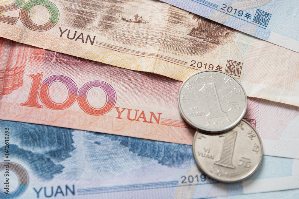 Chinese Yuan banknotes and coins, various denominations as background.
