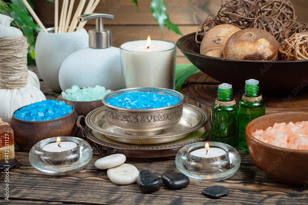 Spa treatment with candles and towel on wooden table, closeup