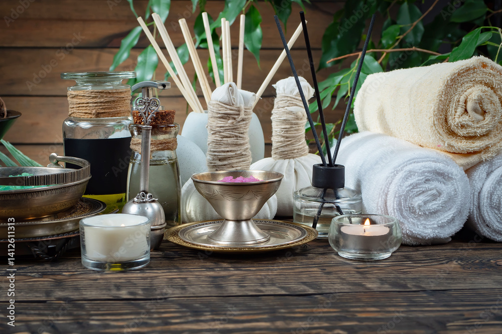 Spa treatment with candles and towel on wooden table, closeup