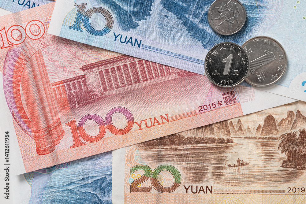 Many of different Chinese yuan banknotes. Chinese paper currency Yuan renminbi banknotes and coins as background.