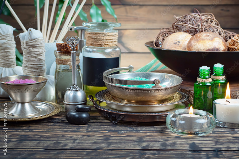 Spa treatment with candles and towel on wooden table, closeup