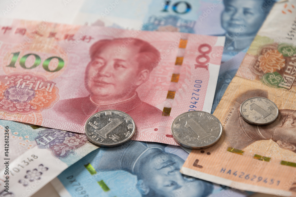 Many of different Chinese yuan banknotes. Chinese paper currency Yuan renminbi banknotes and coins as background.