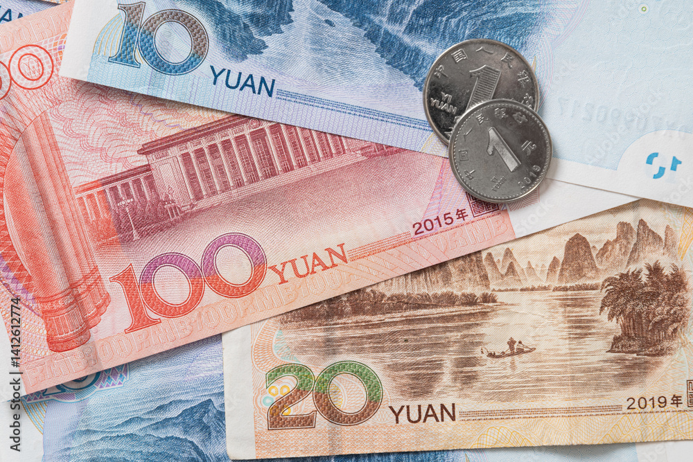 Many of different Chinese yuan banknotes. Chinese paper currency Yuan renminbi banknotes and coins as background.