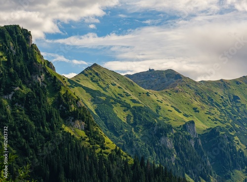 Fototapeta Naklejka Na Ścianę i Meble -  Wild untouched mountain range, deep green valleys. View on peak (Kresanica or Krzesanica) in the Kasprowy Wierch Tatra Mountains. Beautiful landscape in mountain. Summer hiking and healthy lifestyle.