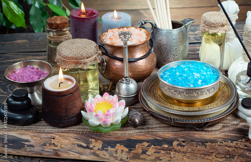 Spa treatment with candles and towel on wooden table, closeup