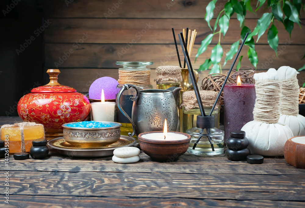 Spa treatment with candles and towel on wooden table, closeup