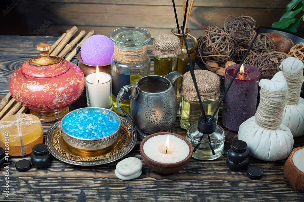 Spa treatment with candles and towel on wooden table, closeup