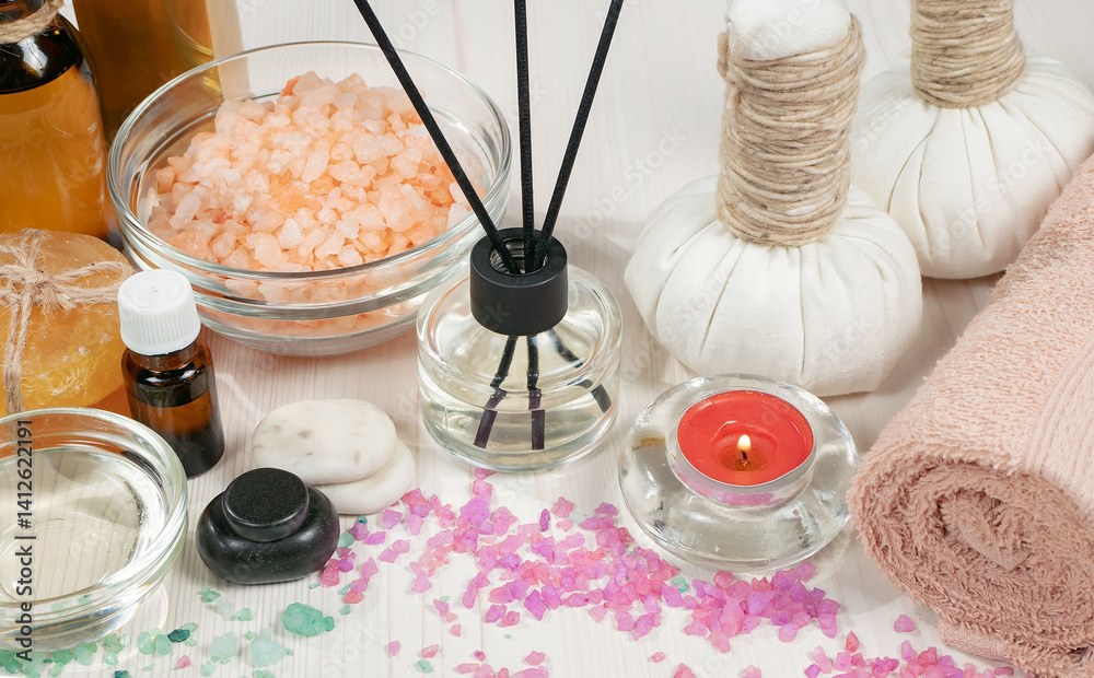 Spa massage items are arranged in a composition on the table.