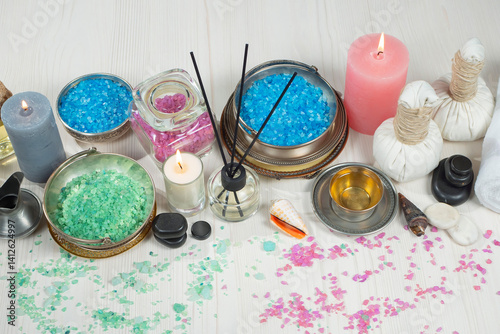 Spa massage items are arranged in a composition on the table.