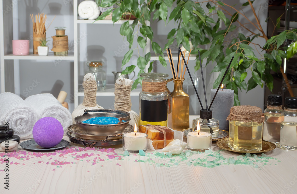 Spa treatment with candles and towel on wooden table, closeup