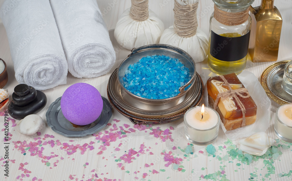 Spa treatment with candles and towel on wooden table, closeup