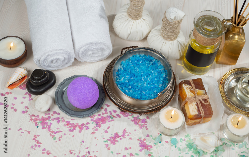 Spa treatment with candles and towel on wooden table, closeup