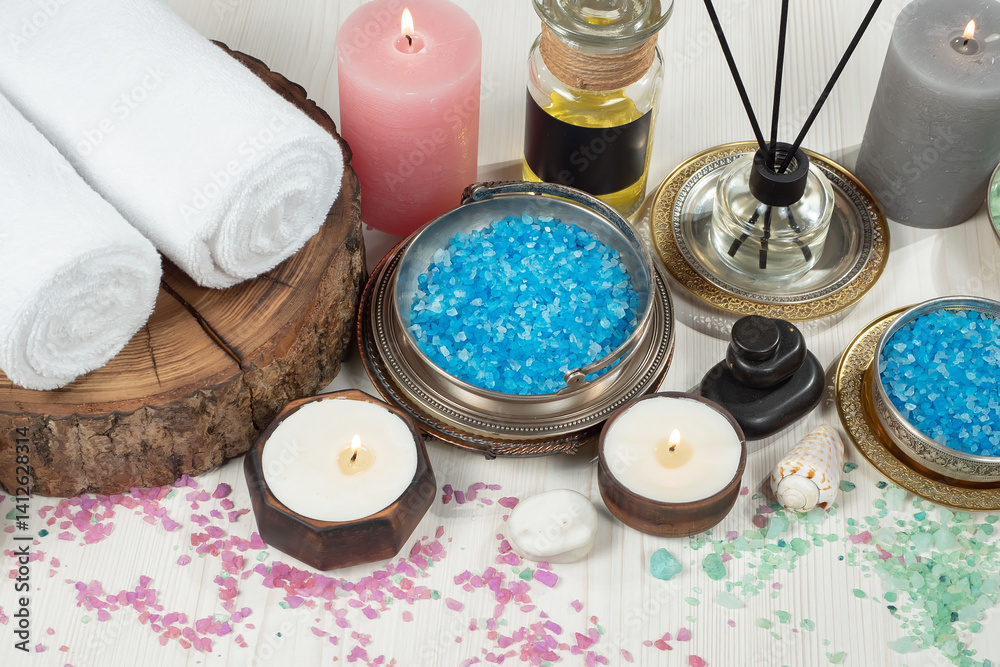 Spa treatment with candles and towel on wooden table, closeup