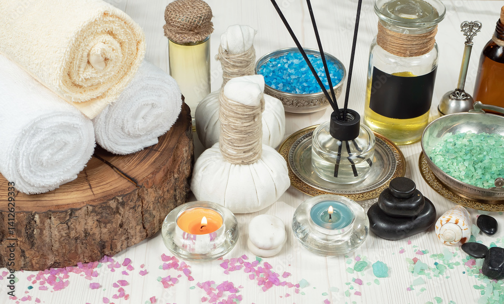 Spa treatment with candles and towel on wooden table, closeup