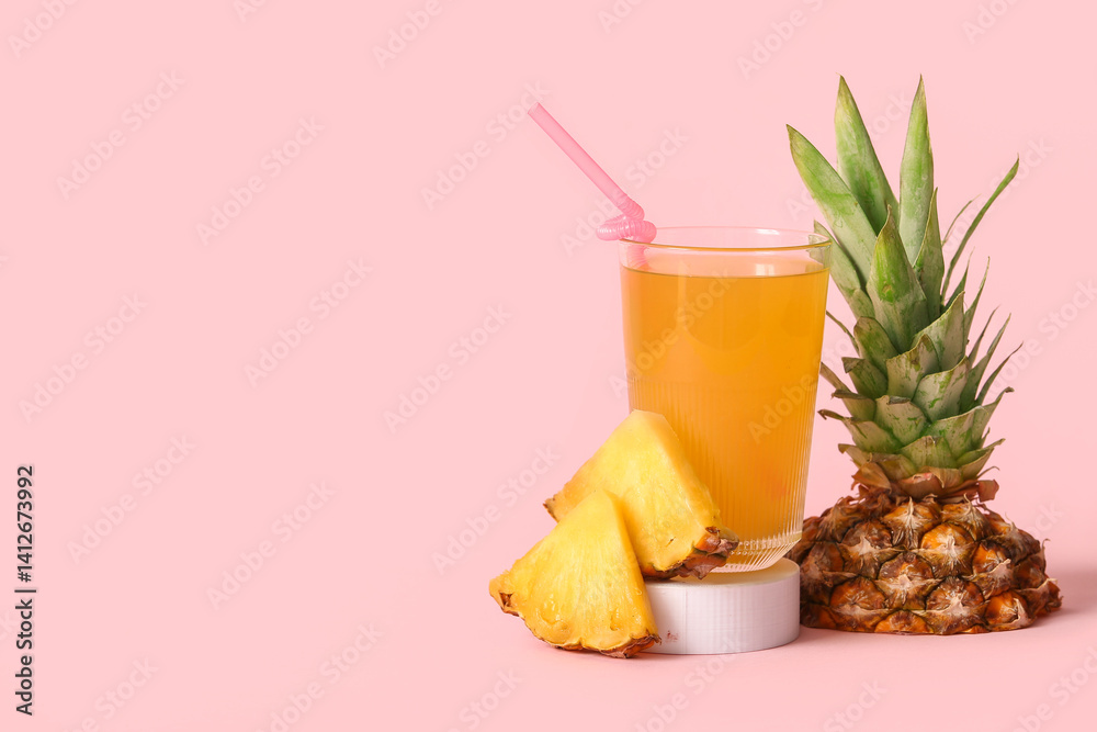 Glass of fresh pineapple juice on stand against pink background Glass of fresh pineapple juice on stand against pink background