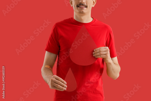 Male blood donor with paper...