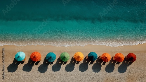 Obraz na płótnie Top view of colorful beach umbrellas aligned on tropical sand ideal for tourism and lifestyle marketing w salonie