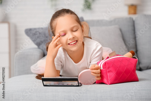 Cute little girl with cosme...