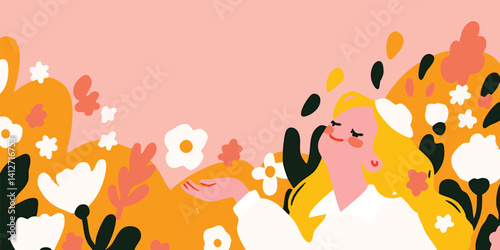 Woman enjoying the scent of flowers in a spring meadow.