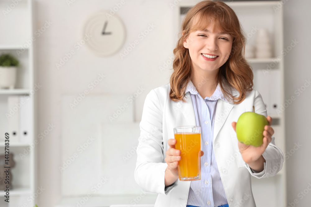 Female nutritionist with glass of juice and apple in office Female nutritionist with glass of juice and apple in office