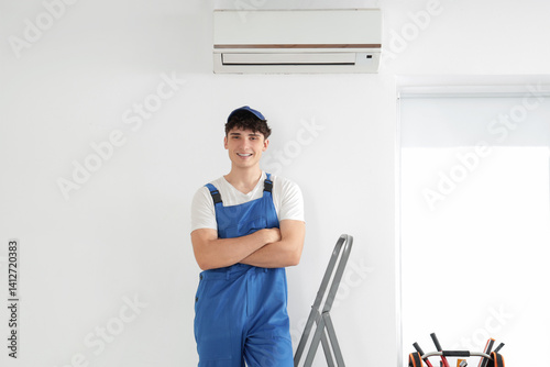 Male worker repairing air c...