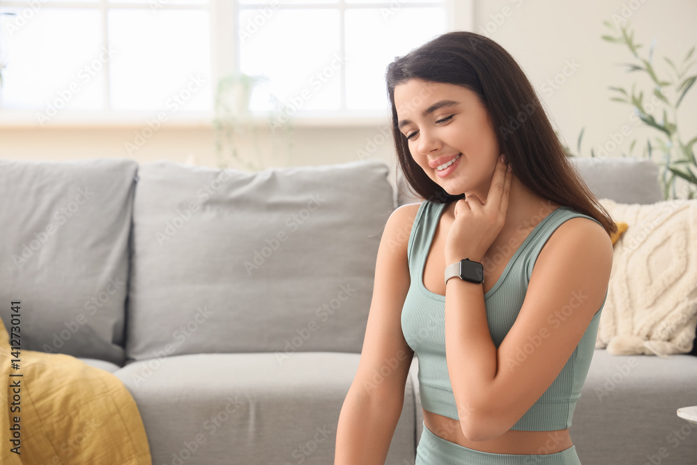 Sporty young woman checking her pulse at home Sporty young woman checking her pulse at home