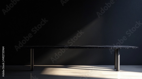 Elegant black marble table with modern metal legs in a minimalist interior