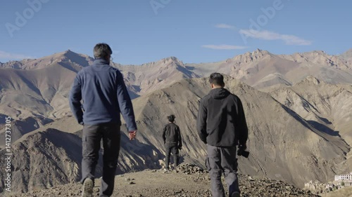 4K footage of Indian photographers clicking photos with various cameras while enjoying the view from Lamayuru moonland in Ladakh.