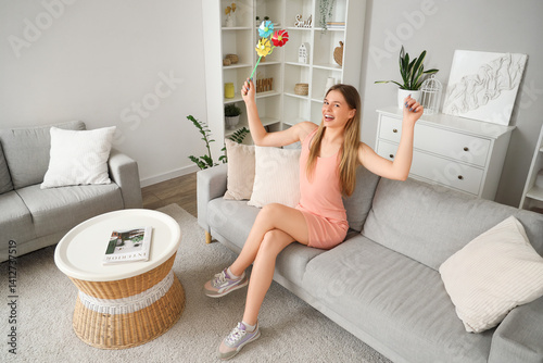 Happy young woman with toy ...
