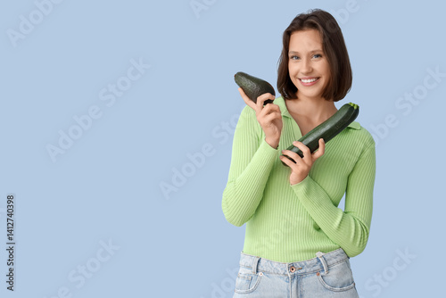 Smiling young woman holding...