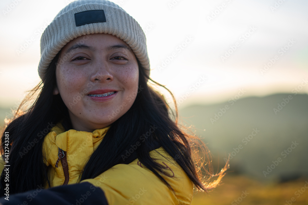 Joyful adventurer embracing nature mountain landscape portrait sunrise close-up freedom