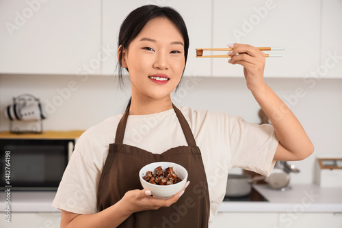Young Asian woman with tast...