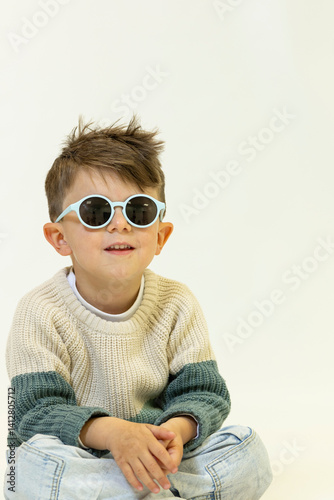 Happy caucasian children posing and playing in commercial studio with copy space