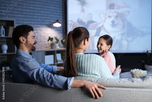 Family watching movie toget...