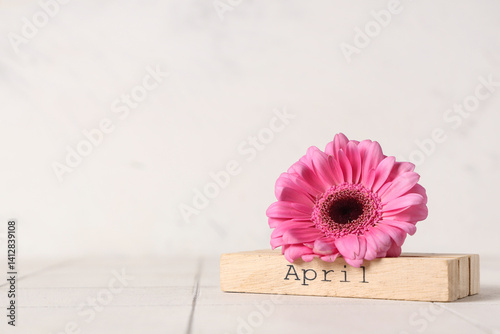 Wooden block with word APRI...