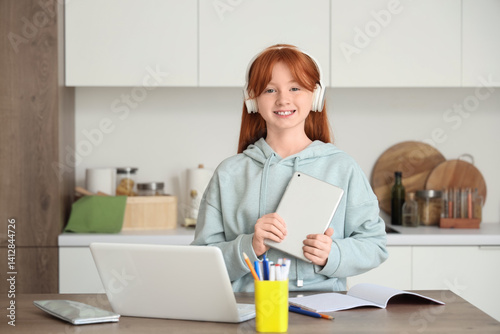 Little redhead girl studyin...