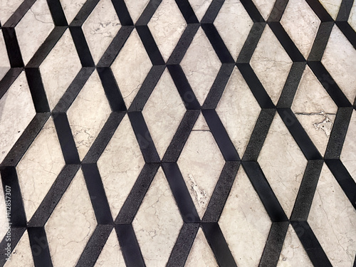 Diamond geometric marble texture cut and arranged like a lattice or net pattern on a floor. Seamless marble flooring art, play with texture and pattern, no people. photo
