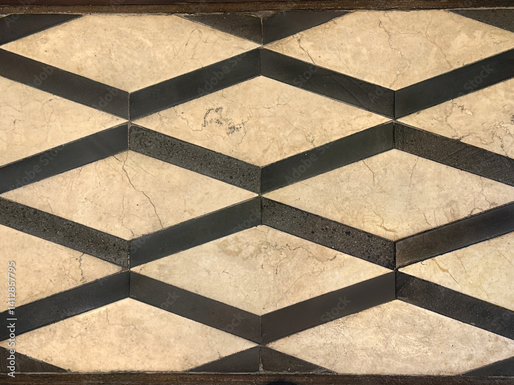 Diamond geometric yellow beige marble texture cut and arranged like a lattice or net pattern on a floor. Seamless marble flooring art, play with texture and pattern, no people.