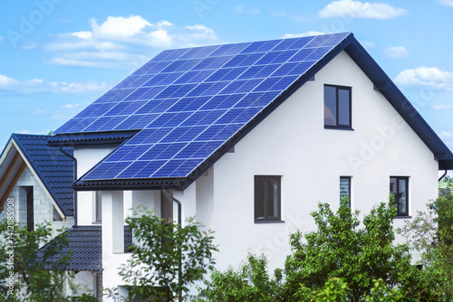Solar Panels on House Full Roof with Landscaping. Modern Eco Home with Green Garden. Solar Power Station of Residential House.