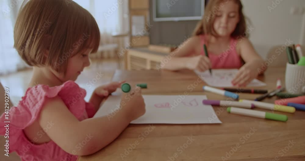A mother and her two daughters enjoy quality time together, drawing and coloring at the dining table in their cozy home. A mother and her two daughters enjoy quality time together, drawing and coloring at the dining table in their cozy home.