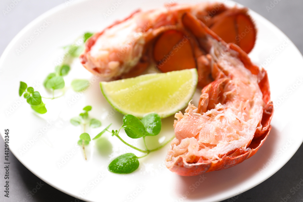 Delicious tail of boiled lobster served on grey table, closeup Delicious tail of boiled lobster served on grey table, closeup